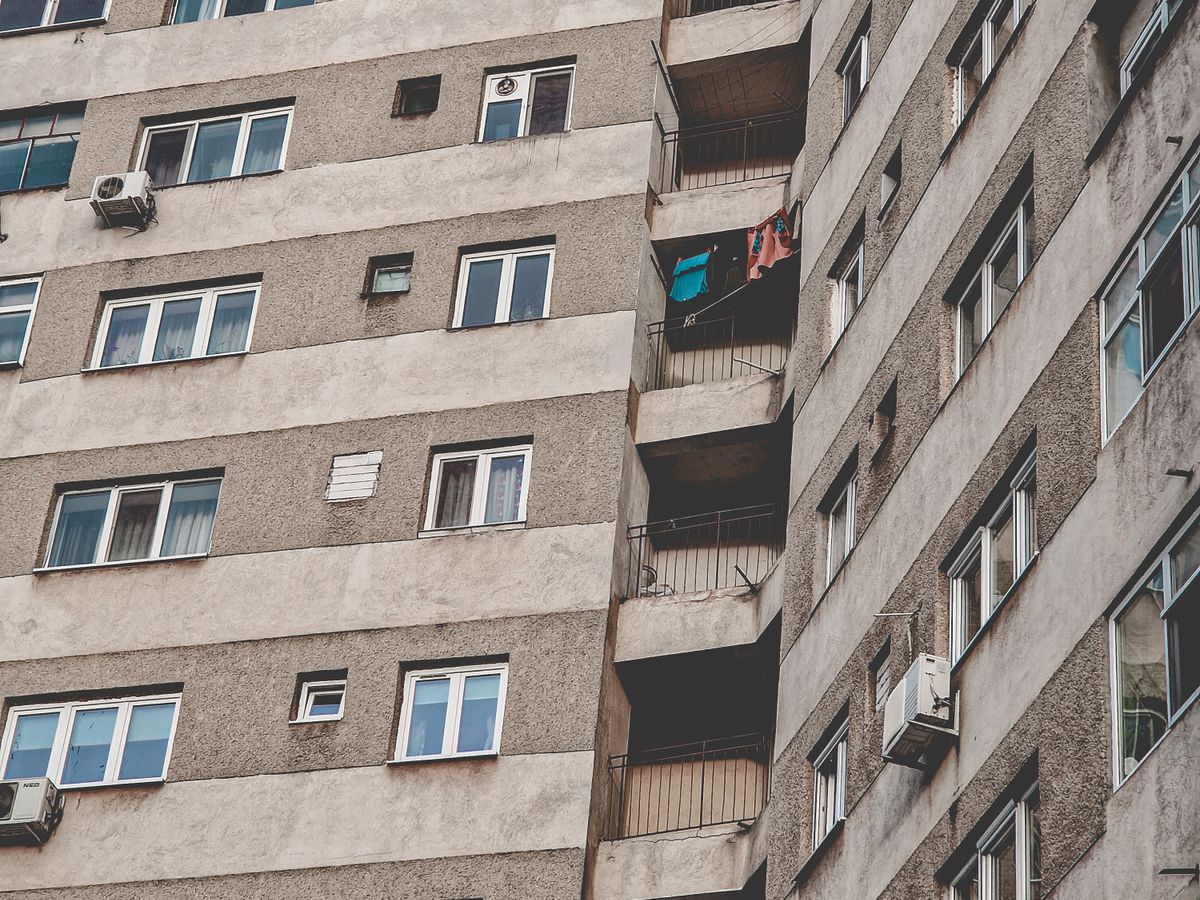 Close-up of a Hong Kong residential apartment block facade with window units and air-conditioners