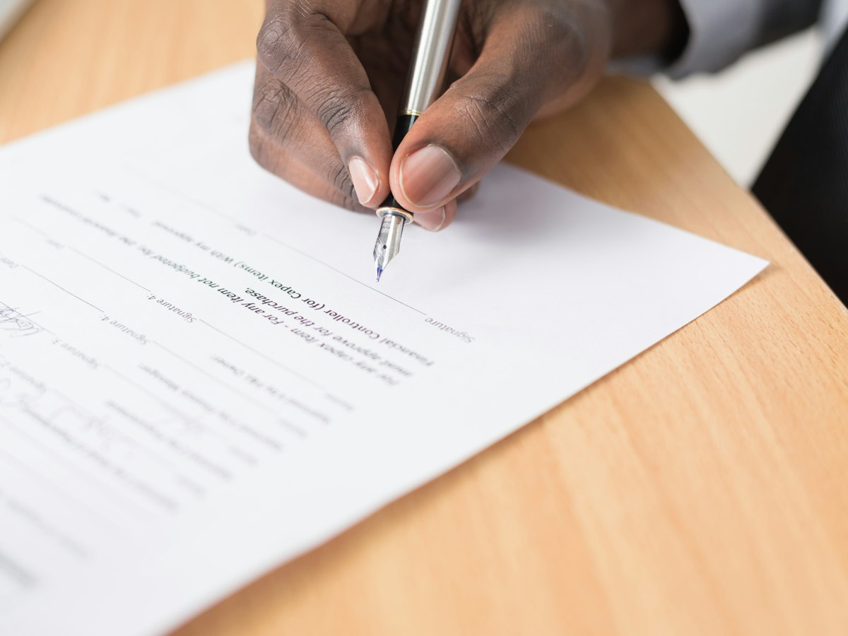 Real estate contract signing document and pen representing estate agency commission agreement in Hong Kong
